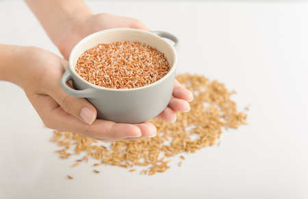 red rice hold by hand studio shotの写真素材