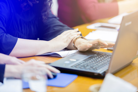 Hands of an business woman typing laptop in meeting room. They are brain business solving problem and brain training concept.の写真素材