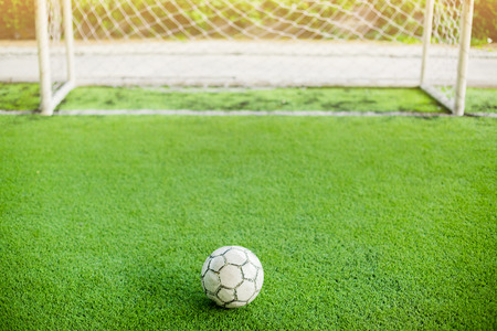 Football on artificial turf and in front of goal. It is for green background and the concept of situationの写真素材