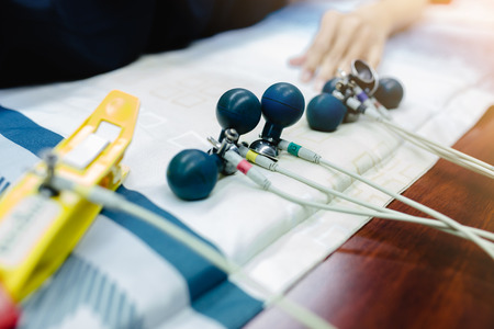 Electrocardiogram for heart and pulse measurement in hospital. Annual health check. Nurse measuring patients blood pressure electrocardiography. ECGの写真素材