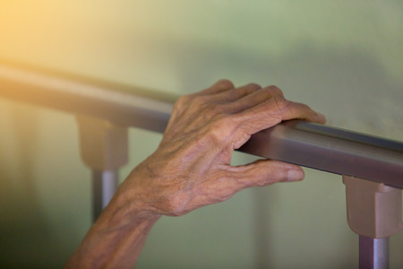 Hand of old woman sleep in bed. Wrinkles of old woman skinの写真素材