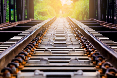 Railway track on steel bridge with selective focus. Train transportation.の写真素材