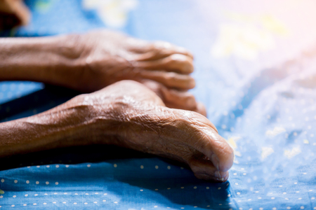 Leg of old woman sleep in bed. Wrinkles of old woman skin.の写真素材