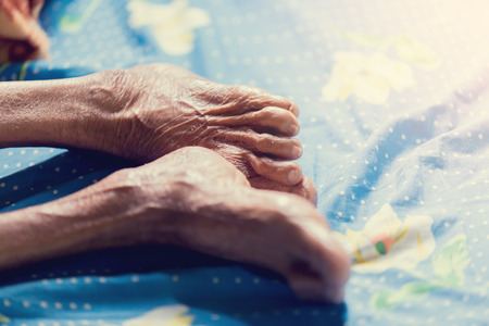 Leg of old woman sleep in bed. Wrinkles of old woman skin.の写真素材