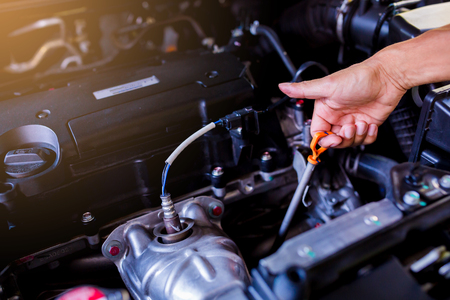 Check the oil level in car engine. Mechanic checking car engine or vehicle. Check and maintenance car with yourself. Service and maintenance vehicle.の写真素材