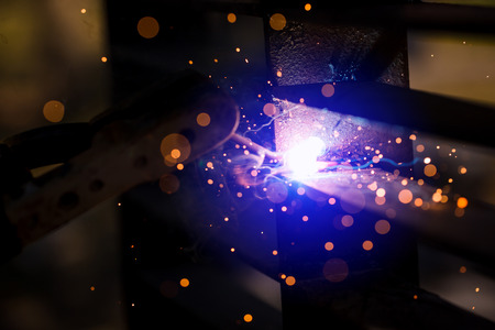 Welder erecting technical steel. Industrial steel welder in factory technical. Welders working at...