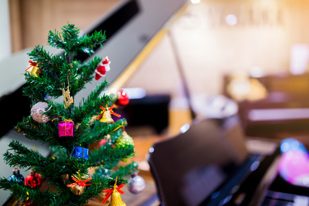 Piano and Christmas tree for christmas holiday. New Year holidays.の写真素材