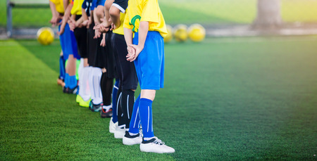 Kid soccer team learning and standing with coach. It is activity on holiday.の写真素材