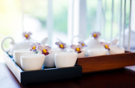 cup and kettle white ceramic on shelves in cafeの写真素材