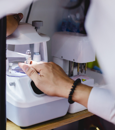 Machine for grinding and trimming lenses for glasses in an optical storeの写真素材