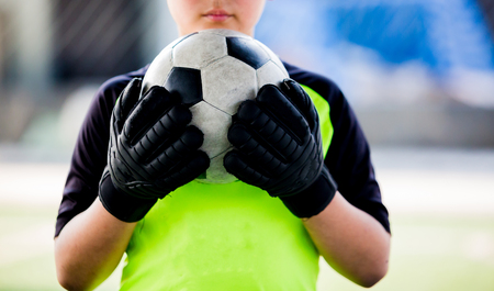 soccer ball in hands of goalkeeper.  Soccer player training or football match.の写真素材