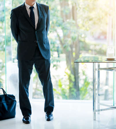 attractive businessman with a laptop bag posting in the hotelの写真素材