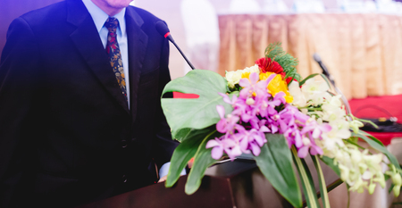 Microphone and business man in an auditorium for shareholders' meeting or seminar event.の写真素材