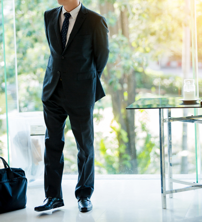 attractive businessman with a laptop bag posting in the hotelの写真素材