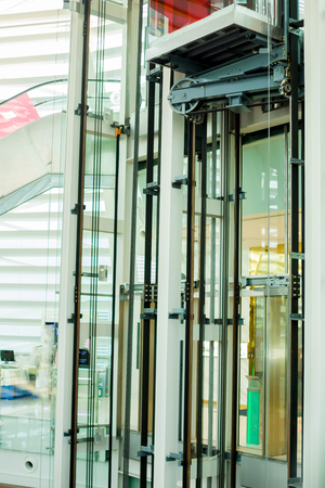wheel rotating with sling cable by motor driven of passenger lift system in department store or office building.の写真素材