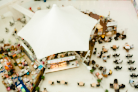 top view of cafe shop & restaurant with table and people on white floor, big white umbrella roof design of cafe shop & restaurant, blur image for backgroundの写真素材