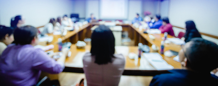 business conference in the meeting room, auditorium for shareholders' meeting or seminar event, many business people listening on the conference, blurry image.