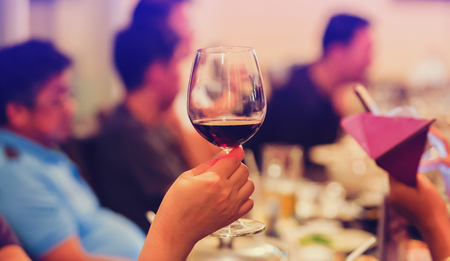 Group of unrecognizable people toasting with wine. Friend toasting saying cheers. Group Of Friends Enjoying Evening Drinks In restaurant. Business People Party Celebration Success Concept.の写真素材