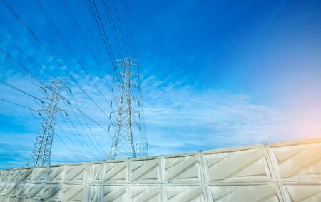 High voltage electric tower line. Silhouette of Power Supply Facilities with blue sky background....