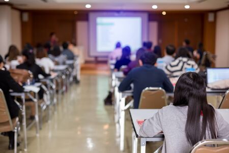 selective focus to business woman and man with blurry speaker for meeting or seminar event in the...