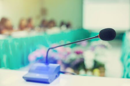 desktop wireless Conference microphones with blurry business group in a meeting room, microphone on the desk in meeting room with blurry people business background. the concept of speaking.の写真素材