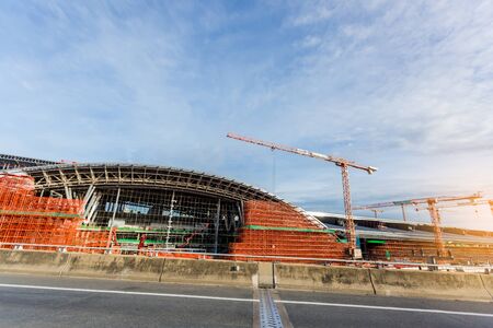scaffolding in the high altitude, scaffolding formed a myriad of grid, industrial and modern urban construction background. Under construction of metal steel framework outdoors buildings with crane.の写真素材