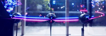 Selective focus to 3D holographic fan advertising machine on glass wall. Revolutionary media...