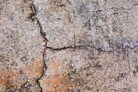 Worn and cracked asphalt with big cracks. Old road concrete texture with cracks. Cement cracked background. Cracks on concrete.の写真素材