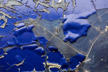 Close-up of old blue car paint broken, crack color of automobile.Car paint cracks, Cracked painted metal surface. Closeup of cracked and peeling paint on an old car.の写真素材