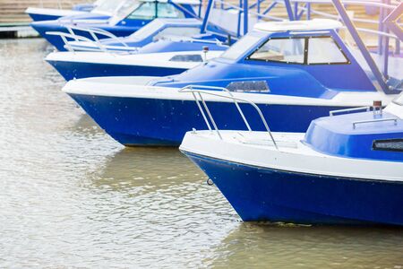 Pier white and blue speedboat. A marina lot. yachts and speed boats at harbor. Ocean Coast pier. River pier. Thailand.の写真素材