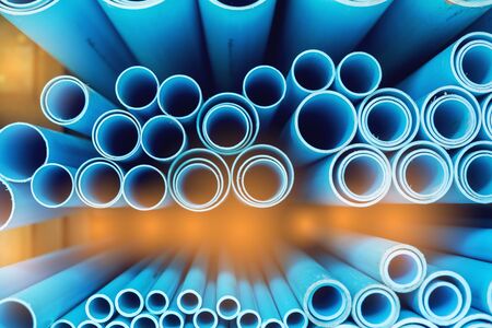 Close up to blue plastic pipe background, PVC pipes stacked in warehouse, PVC water pipes used for construction.の写真素材