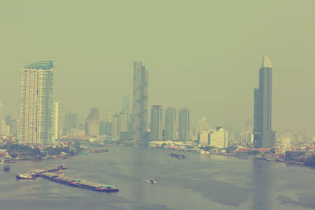 Bangkok office buildings and condominium with Chao Phraya river and chips. Office building under...
