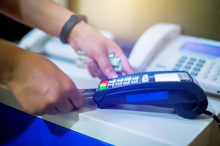 Hand put credit card In slot of credit card reader, credit card payment, buy and sell products &...