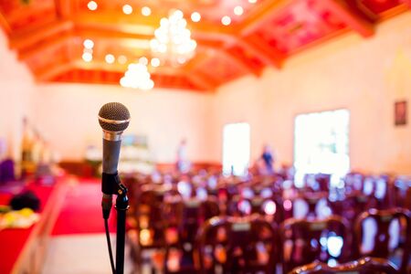 Microphone with blurry indoor location for Buddhist activities. The concept of speaker.