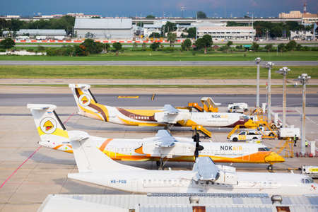 Bangkok, Thailand - June 25, 2020 : Nok Air 's many planes stopped flight in don mueang international airport due to the impact of the Coronavirus Covid-19 outbreak. Many colorful aircraft in airport.のeditorial素材