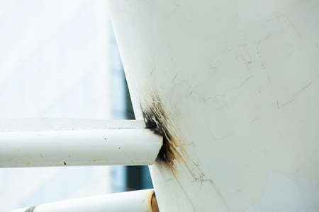 Weld seam of Steel weld joined pipe to white steel framework outdoors buildings. Industrial urban construction background.の写真素材