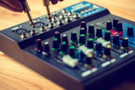 Selective focus to sound electronics mixer and gold mic jack. Music and live sound.