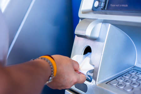 Selective focus to customer hand get slip from ATM Machine.の写真素材