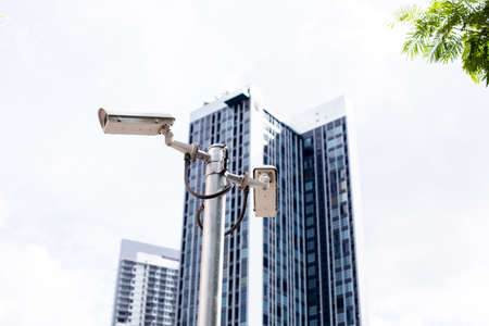 Selective focus to CCTV Camera with blurry modern building.の写真素材