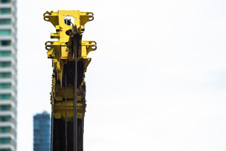 Yellow telescopic â€‹arms with hoist and sling of mobile construction crane. Thailand.