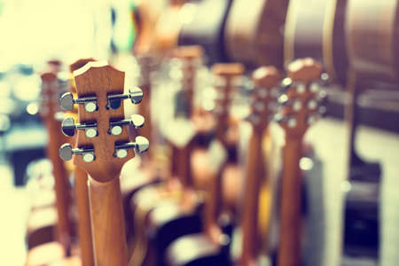 Selective focus to guitar tuning knob with blurry  many guitar in musical showroom at musical store. Instrument concept.の写真素材
