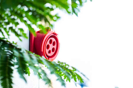 Red connectors for charging electric vehicles in service stations.の写真素材