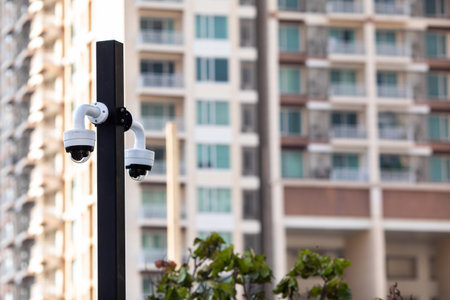 Selective focus to CCTV Camera with blurry modern building.