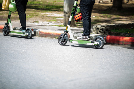 An officer is riding a electric scooter on the road. Versatility of using a scooter.の写真素材