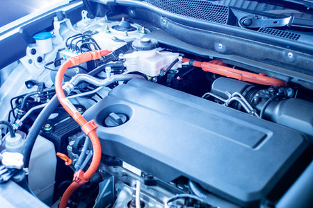 Selective focus to hybrid automotive industry part of modern new car engine room, Machine show all parts and open hood. Engine and electric motor room of new car.の写真素材