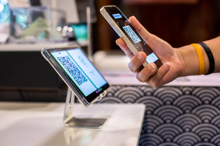 Selective focus to Smartphone in hand to scan QR code payment tag in restaurant to accepted generate digital pay without money. Qr code payment concept.の写真素材