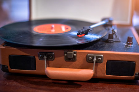 Selective focus to vintage record player on a table in a music studio playing an old vinyl album. Close-up image of a vintage record player for vinyl.の写真素材