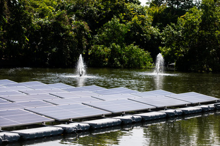 Selective focus to solar power station. Solar photovoltaic power station on water. Solar panels or solar cells on buoy floating in lake.  Power plant with water, renewable energy source.の写真素材