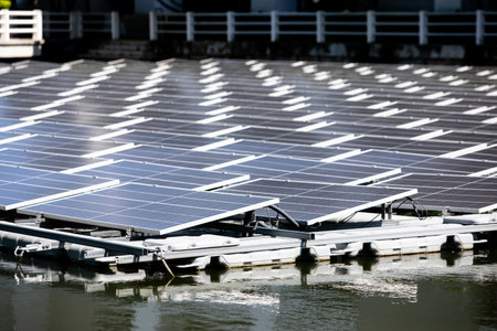 Selective focus to solar power station. Solar photovoltaic power station on water. Solar panels or solar cells on buoy floating in lake.  Power plant with water, renewable energy source.の写真素材