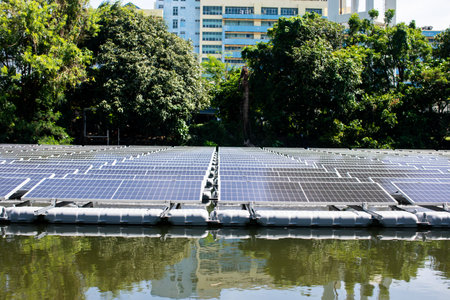 Selective focus to solar power station. Solar photovoltaic power station on water. Solar panels or solar cells on buoy floating in lake.  Power plant with water, renewable energy source.の写真素材